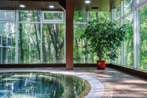 indoor-tiled-hot-tub-with-panoramic-forest-view solarium