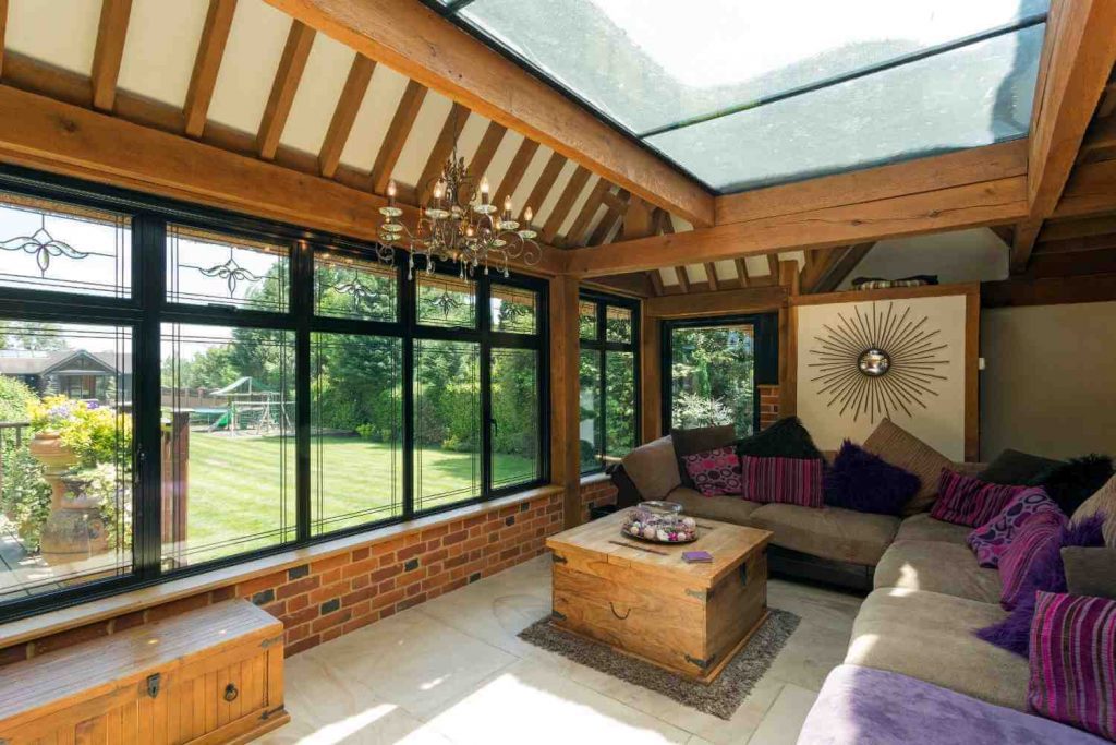 timber-framed-conservatory-with-brick-wall-and-garden-view